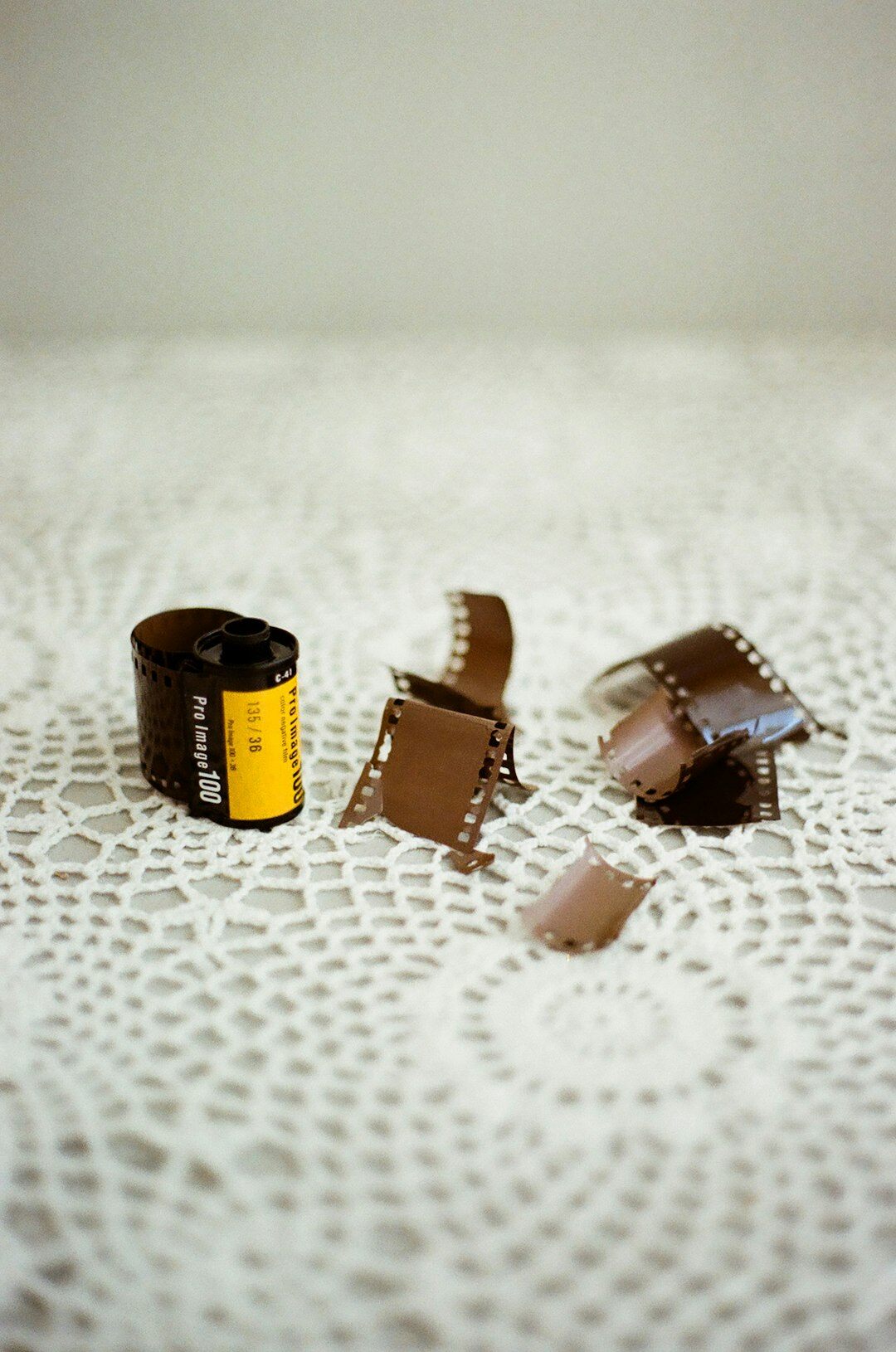 Vintage film camera and rolls of negatives still life